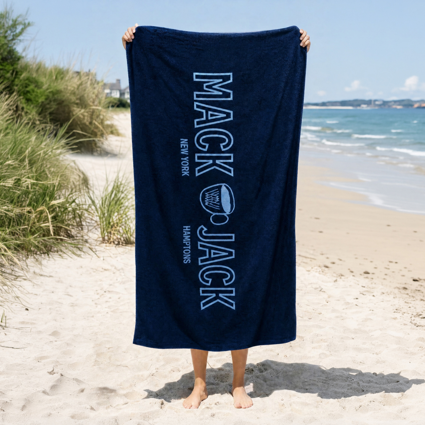 Man holding a Mack Weldon x Jack’s Coffee Beach Towel